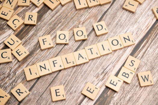 Wooden scrabble tiles arrange to spell 'Food Inflation' on a rustic wooden surface, conceptually depicting rising food prices.